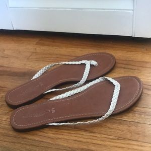 White and tan flip flops